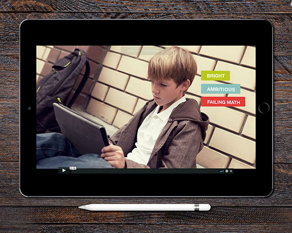 Screenshot from the Daxko Engage video on an iPad, featuring a little boy looking sad and doing his homework on a laptop; width=375;” height=