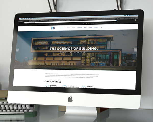 The front page of the HPM website on an iMac