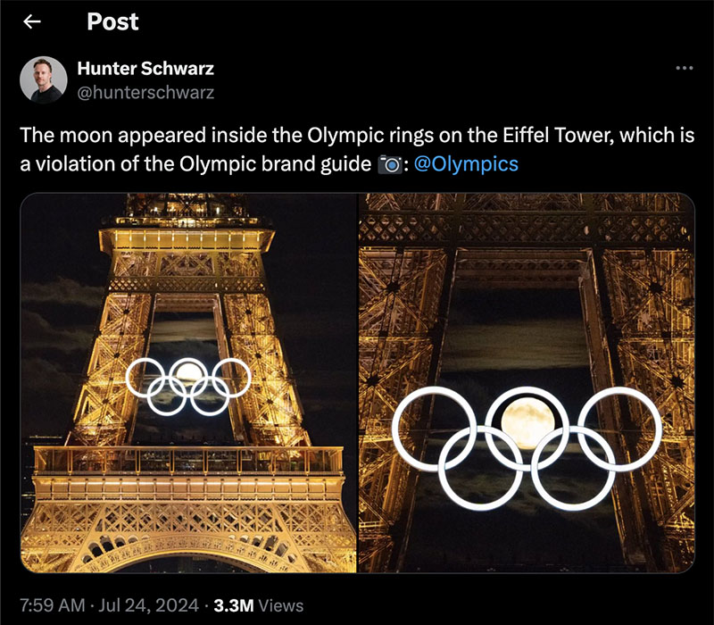 Screenshot of a tweet by @hunterschwarz. The tweet reads, “The moon appeared inside the Olympic rings on the Eiffel Tower, which is a violation of the Olympic brand guide: @olympics.” The two photos underneath show a long shot and a close-up of the spotlit Eiffel Tower at night with the Olympic ring logo attached to the side. The full moon is visible perfectly framed by the top center ring.