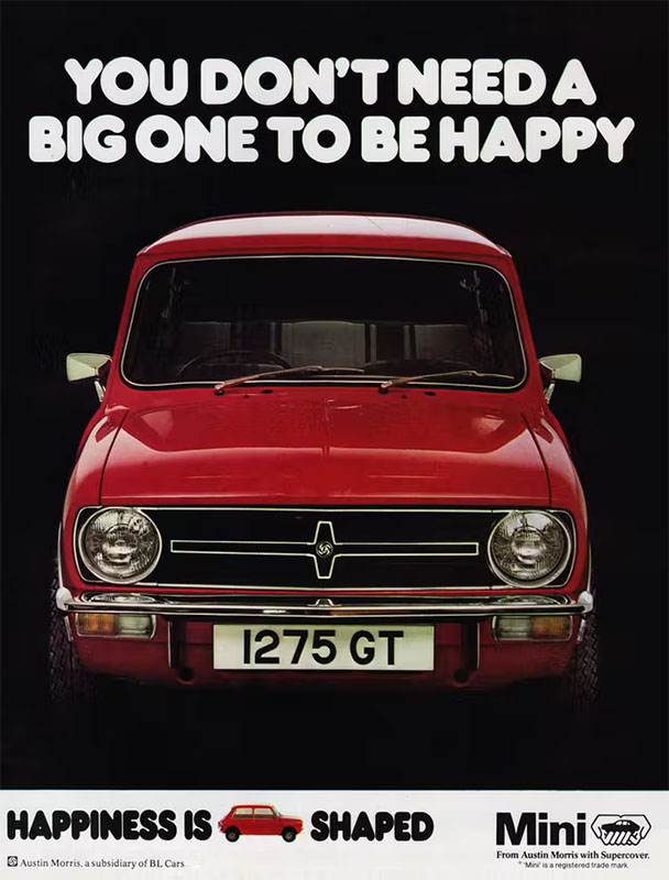 A 1979 Mini print ad. The ad shows a red 1979 Mini against a black background. The headline, in white bubble letters, reads, “You don’t need a big one to be happy.”