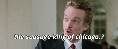 A gif from "Ferris Bueller's Day Off," with a close-up of a snooty man in a dark suit, precisely coiffed blonde '80s hair, and skinny mustache rolling his eyes and mockingly saying, as displayed in white text at the bottom of the frame, "The sausage king of Chicago?"
