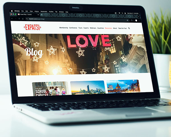 The front page of the Expatsi Expat Blog, shown on the screen of a MacBook